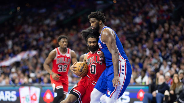 Chicago Bulls guard Coby White (0) drives against Philadelphia 76ers center Joel Embiid (21) during the third quarter at Wells Fargo Center.